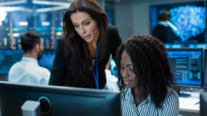 Security team looking at a computer monitor.
