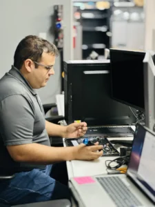 7tech-Service-Tech-Michael-Working-on-Laptop Service Desk Technician, Michael Gonzalez working on an open laptop.