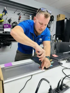 7tech-Service-Technician-Dustin-Working-On-Laptop copy Service Desk Technician, Dusten Russell putting back together a laptop.