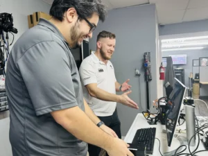 Charlie-and-Dustin-Collaborating-On-PC-Update copy 7tech's service desk technicians Charlie and Dusten working together on PC workstation.