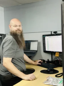 Tom-At-Desk copy Service Desk Specialist, Tom Walsh standing at desk.