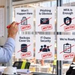 6 Construction Cybersecurity Myths That Put Your Business at Risk Construction cybersecurity myths reviewed in an office.