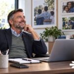 executive at desk happy that overlooked technology habits for nonprofits are gone